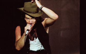LONDON, UNITED KINGDOM - JUNE 12: Bono of U2 performs on stage at Wembley Stadium on June 12th, 1987 on 'The Joshua Tree' tour in London, England. (Photo by Pete Still/Redferns)