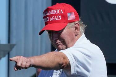 TOPSHOT - Former US President Donald Trump points at the crowd as he attends Round 3 of the LIV Golf-Bedminster 2023 at the Trump National in Bedminster, New Jersey on August 13, 2023. Donald Trump was indicted August 14, 2023 on charges of racketeering and a string of election crimes after a sprawling two-year probe into his efforts to overturn his 2020 defeat to Joe Biden in the US state of Georgia, according to a court filing.
The case -- relying on laws typically used to bring down mobsters -- is the fourth targeting the 77-year-old Republican this year and could lead to a watershed moment, the first televised trial of a former president in US history. (Photo by TIMOTHY A. CLARY / AFP) (Photo by TIMOTHY A. CLARY/AFP via Getty Images)