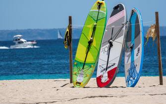 epa09301059 Surf boards are seen at Punta Ballena in Magaluf, Majorca, Spain, 25 June 2021. Balearic Islands is on Britain's green travel list which will allow British nationals to visit the islands during their holidays without the need of undergoing quarantine when they return back to the UK.  EPA/CATI CLADERA