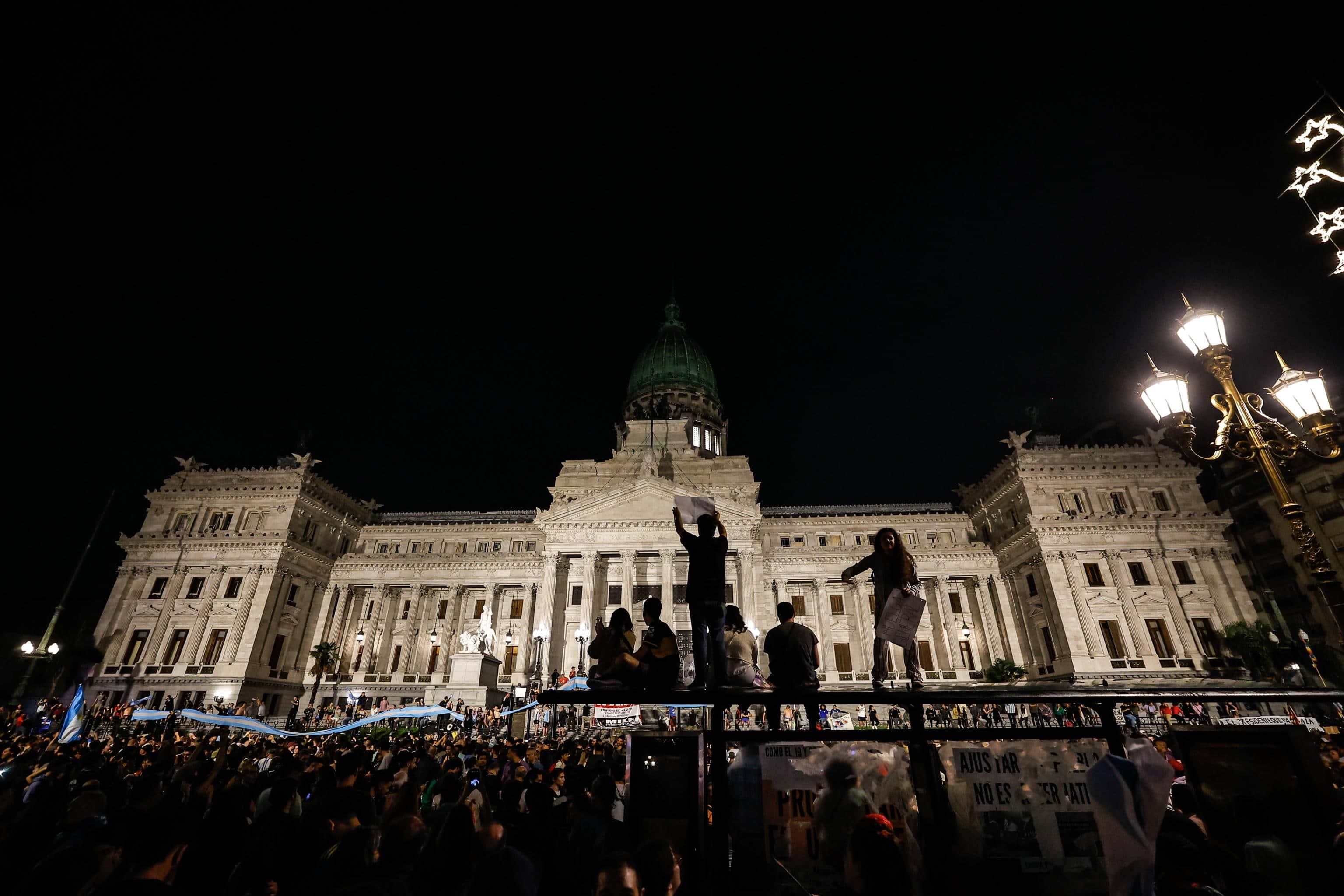 epa11039565 Dozens of people participate in a demonstration against the economic measures announced by President Javier Milei, in front of the National Congress in Buenos Aires, Argentina, 20 December 2023. Milei announced a plan that contemplates the reform of more than 300 regulations to lay 'the foundations for the reconstruction of the Argentine economy.' The announcement of the Government's shock plan occurred on the same day that some 3,000 people called by social and left-wing organizations took to the streets of the Argentine capital to show their rejection of the policy of the ultra-liberal president.  EPA/Juan Ignacio Roncoroni