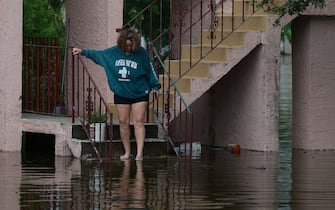 TARPON SPRINGS, FLORIDA - AUGUST 30: Tina Kruse looks out at the flood waters from Hurricane Idalia surrounding her apartment complex on August 30, 2023 in Tarpon Springs, Florida. Hurricane Idalia is hitting the Big Bend area of Florida.  (Photo by Joe Raedle/Getty Images)