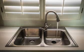 sink in a kitchen with running tap water