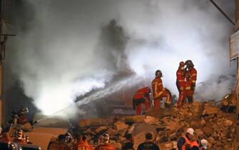 Rescue personnel work at the scene where a building collapsed in the southern French port city of Marseille  early on April 9, 2023. - A building in the southern French port city of Marseille collapsed, police told AFP early on April 9, though it was unclear whether there were any victims. (Photo by NICOLAS TUCAT / AFP) / The erroneous mention[s] appearing in the metadata of this photo by NICOLAS TUCAT has been modified in AFP systems in the following manner: [April 9] instead of [March 9]. Please immediately remove the erroneous mention[s] from all your online services and delete it (them) from your servers. If you have been authorized by AFP to distribute it (them) to third parties, please ensure that the same actions are carried out by them. Failure to promptly comply with these instructions will entail liability on your part for any continued or post notification usage. Therefore we thank you very much for all your attention and prompt action. We are sorry for the inconvenience this notification may cause and remain at your disposal for any further information you may require. (Photo by NICOLAS TUCAT/AFP via Getty Images)