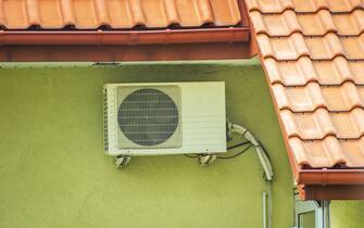 Air conditioner hanging on the wall of the building