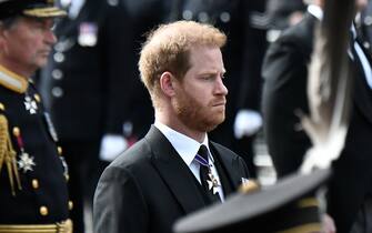 LONDON, ENGLAND - SEPTEMBER 19: Prince Harry, Duke of Sussex, follows the coffin of Queen Elizabeth II, draped in the Royal Standard, on the State Gun Carriage of the Royal Navy, as it travels from Westminster Abbey to Wellington Arch on September 19, 2022 in London, England. Elizabeth Alexandra Mary Windsor was born in Bruton Street, Mayfair, London on 21 April 1926. She married Prince Philip in 1947 and ascended the throne of the United Kingdom and Commonwealth on 6 February 1952 after the death of her Father, King George VI. Queen Elizabeth II died at Balmoral Castle in Scotland on September 8, 2022, and is succeeded by her eldest son, King Charles III.  (Photo by Stephane De Sakutin - WPA Pool/Getty Images)