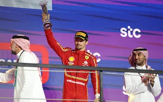epa11209862 Third placed Scuderia Ferrari driver Charles Leclerc of Monaco celebrates with the trophy on the podium after the Formula 1 Saudi Arabia Grand Prix at the Jeddah Corniche Circuit in Jeddah, Saudi Arabia, 09 March 2024.  EPA/ALI HAIDER