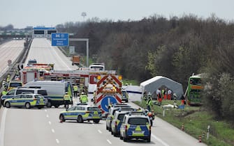 Emergency and police vehicles stand on the A9 highway at the scene of an accident where at least five people were killed on March 27, 2024 in Schkeuditz, near Leipzig, eastern Germany. (Photo by Jens Schlueter / AFP) (Photo by JENS SCHLUETER/AFP via Getty Images)