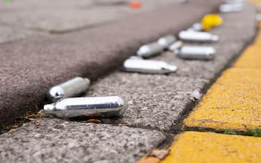 CARDIFF, UNITED KINGDOM - JUNE 27: Used metal canisters of nitrous oxide, also known as hippy crack or happy gas, left on the floor at Roald Dahl Plass in Cardiff Bay following a lockdown party on June 27, 2020 in Cardiff, United Kingdom. The First Minister of Wales Mark Drakeford has announced that all non-essential shops will be allowed to open their doors again in Wales from Monday but people will be asked to continue to "stay local" with five miles given as guidance until July 6. (Photo by Matthew Horwood/Getty Images)
