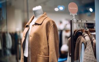 Women's clothing displayed in the boutique window. Retail and consumerism