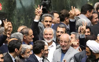 epa11510677 Hamas political leader Ismail Haniyeh (C) flashes victory sign as surrounded by Iranian lawmakers at the Iranian parliament in Tehran, Iran, 30 July 2024 (issued 31 July 2024). According to an Iranian Revolutionary Guard Corps (IRGC) statement on 31 July 2024, Haniyeh and one of his bodyguards were targeted and killed in Tehran on 31 July 2024.  EPA/ABEDIN TAHERKENAREH