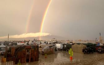 04 September 2023, USA, Black Rock: Undated image shows rainbow seen over the muddy grounds of the "Burning Man" festival. Tens of thousands of visitors to the desert festival "Burning Man" are stranded on the site in the US state of Nevada after heavy rainfall over the weekend. Photo: David Crane/dpa (Photo by David Crane/picture alliance via Getty Images)