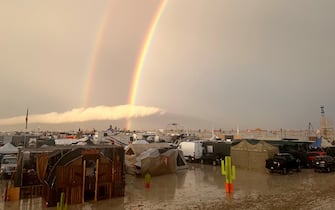 04 September 2023, USA, Black Rock: Undated image shows rainbow seen over the muddy grounds of the "Burning Man" festival. Tens of thousands of visitors to the desert festival "Burning Man" are stranded on the site in the US state of Nevada after heavy rainfall over the weekend. Photo: David Crane/dpa (Photo by David Crane/picture alliance via Getty Images)