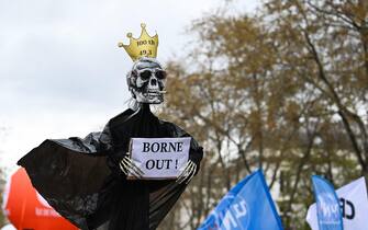 A protestor holds a puppet during a demonstration on the 11th day of action after the government pushed a pensions reform through parliament without a vote, using the article 49.3 of the constitution, in Paris on April 6, 2023. - France on April 6, 2023 braced for another day of protests and strikes to denounce French President's pension reform one day after talks between the government and unions ended in deadlock. (Photo by Alain JOCARD / AFP)
