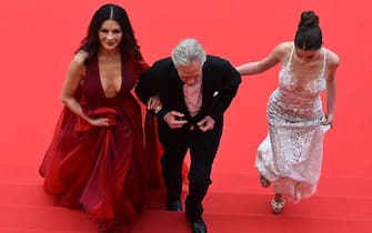 US actor and Honorary Palme d'or of the 76th Festival de Cannes Michael Douglas (C) arrives with his wife British actress Catherine Zeta-Jones (L) and daughter Carys for the opening ceremony and the screening of the film "Jeanne du Barry" during the 76th edition of the Cannes Film Festival in Cannes, southern France, on May 16, 2023. (Photo by Antonin THUILLIER / AFP) (Photo by ANTONIN THUILLIER/AFP via Getty Images)