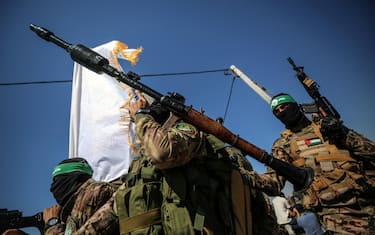 

Palestinian fighters from the armed wing of Hamas are taking part in a military parade in front of an Israeli military site to mark the anniversary of the 2014 war with Israel, near the border in the central Gaza Strip, on July 19, 2023. (Photo by Majdi Fathi/NurPhoto)