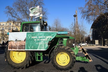 A farmer drives a tractor past the Eiffel Tower during a demonstration organised by unions including FNSEA (National Federation of Farmers Union), against "obligations" in agriculture, in particular restrictions on the use of pesticides, at Porte de Versaille, in Paris, on February 8, 2023. (Photo by Bertrand GUAY / AFP) (Photo by BERTRAND GUAY/AFP via Getty Images)