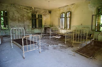 VENICE, ITALY - AUGUST 27:   Beds and furniture remain in one of the dormitories in the psychiatric ward of the abandoned Hospital of Poveglia on August 27, 2011 in Venice, Italy. The island of Poveglia, with its ruined hospital and plague burial grounds, is said to be the most haunted location in the world. The area is located within a multi-million dollar piece of real estate but is deserted and off limits to the public. The dark and derelict forbidding shores are only minutes away from the glamour of the Venice Film Festival on the Lido.  (Photo by Marco Secchi/Getty Images)