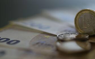 Money.Euro coins and euro banknotes on a green background.