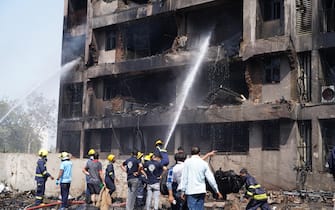 epa12171339 Firefighters work at the site of a plane crash near Sardar Vallabhbhai Patel International Airport in Ahmedabad, Gujarat, western India, 12 June 2025. Air India flight AI171, bound for London carrying 242 passengers and crew members on board a Boeing 787-8 aircraft, crashed minutes after take-off in the Meghaninagar area of Ahmedabad.  EPA/SIDDHARAJ SOLANKI