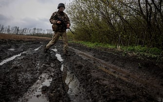 A Ukrainian infantryman of the 57th Separate Motorized Infantry Brigade "Otaman Kost Khordienko" walks down a muddy road in east Ukraine, on April 13, 2023, amid Russia's military invasion on Ukraine. (Photo by ANATOLII STEPANOV / AFP) (Photo by ANATOLII STEPANOV/AFP via Getty Images)