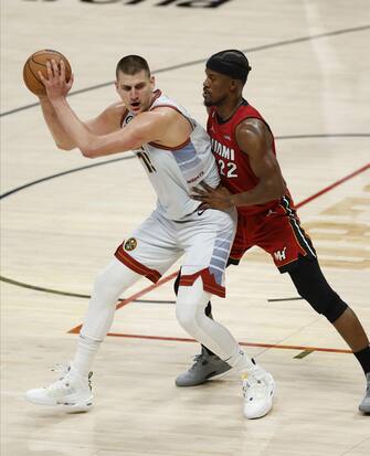 epa10687794 Denver Nuggets center Nikola Jokic of Serbia (L) is guarded by Miami Heat forward Jimmy Butler (R) during the second half of game five of the NBA Finals between the Miami Heat and the Denver Nuggets at Ball Arena in Denver, Colorado, USA, 12 June 2023.  EPA/JOHN G. MABANGLO  SHUTTERSTOCK OUT