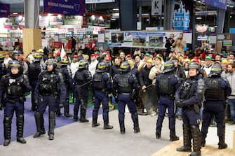 PARIS, FRANCE - FEBRUARY 24: 
Members of the French police stand guard as French farmers protest inside the Porte de Versailles exhibition centre on the day of French President Emmanuel Macron's visit to the International Agriculture Fair (Salon International de l'Agriculture) during its inauguration on February 24, 2024 in Paris, France. Several dozen demonstrators entered the Salon without authorization on Saturday morning to try to meet the Head of State after several weeks of mobilizations by part of the agricultural world. (Photo by Chesnot/Getty Images)