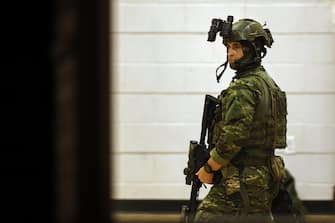 epa10939859 A police officer in tactical gear gets ready in the Lisbon High School gymnasium as an active search for the shooter is underway following a mass shooting during which a man on late 25 October reportedly opened fire this evening killing and injuring numerous people in Lewiston, in Lisbon, Maine, USA, 26 October 2023. Early reports on 25 October, indicate multiple fatal casualties, and dozens of injured. Police are still searching for the suspect and county officials have declined to give answers regarding the number of the victims so far.  EPA/CJ GUNTHER