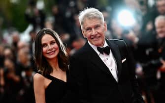 US actor Harrison Ford (R) arrives with his wife Calista Flockhart for the screening of the film "Indiana Jones and the Dial of Destiny" during the 76th edition of the Cannes Film Festival in Cannes, southern France, on May 18, 2023. (Photo by LOIC VENANCE / AFP) (Photo by LOIC VENANCE/AFP via Getty Images)