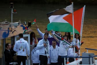 epa11497771 Athletes from Palestine wave their flag during the Opening Ceremony of the Paris 2024 Olympic Games, in Paris, France, 26 July 2024.  EPA/MOHAMMED BADRA