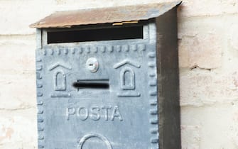 postal box on a wall in tuscany, italy