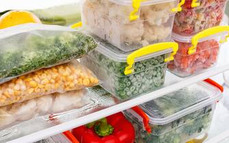 Frozen food in the refrigerator. Vegetables on the freezer shelves. Stocks of meal for the winter.