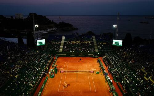 TOPSHOT - Italy's Fabio Fognini (up) returns the ball to Croatia's Borna Coric during their quarter final tennis match on Day 7 of the Monte-Carlo ATP Masters Series tournament on April 19, 2019 in Monaco. (Photo by VALERY HACHE / AFP)        (Photo credit should read VALERY HACHE/AFP via Getty Images)
