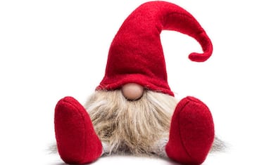 Red sitting christmas elf with pointed cap isolated as template