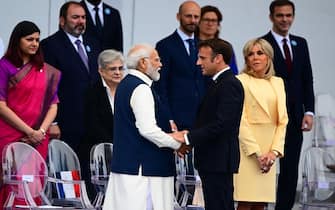 French President Emmanuel Macron greets India's Prime Minister Narendra Modi during the Bastille Day military parade on the Champs-Elysees avenue in Paris on July 14, 2023. (Photo by Emmanuel DUNAND / AFP) (Photo by EMMANUEL DUNAND/AFP via Getty Images)