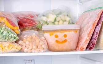 Frozen food in the freezer. Frozen vegetables, soup, ready meals in the freezer