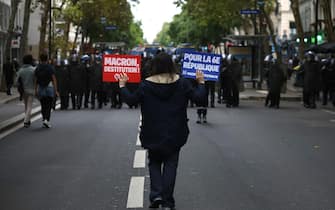 epa11591334 People attend a protest rally in Paris, France, 07 September 2024 as the French left parties called for rallies against President Macron's politics. Protests are taking place across France over the appointment of Michel Barnier as the new French prime minister, after the election that resulted in a National Assembly without a majority and in which the left won the largest number of seats. The poster reads "Macron destitution, For the 6th republic''.  EPA/YOAN VALAT