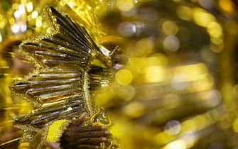 A reveler of the Barroca Zona Sul samba school performs during the second night of carnival at the Sambadrome in Sao Paulo, Brazil on March 1, 2025. (Photo by Miguel SCHINCARIOL / AFP)