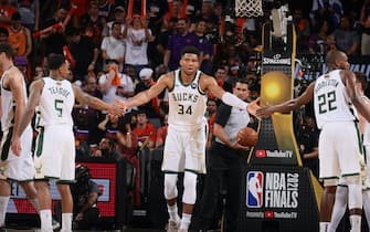 PHOENIX, AZ - July 8: Giannis Antetokounmpo #34 of the Milwaukee Bucks high fives Jeff Teague #5 of the Milwaukee Bucks and Khris Middleton #22 of the Milwaukee Bucks during Game Two of the 2021 NBA Finals on July 8, 2021 at Phoenix Suns Arena in Phoenix, Arizona. NOTE TO USER: User expressly acknowledges and agrees that, by downloading and or using this photograph, user is consenting to the terms and conditions of the Getty Images License Agreement. Mandatory Copyright Notice: Copyright 2021 NBAE (Photo by Nathaniel S. Butler/NBAE via Getty Images)