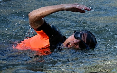 Paris Mayor Anne Hidalgo swims in the Seine, in Paris on July 17, 2024, to demonstrate that the river is clean enough to host the outdoor swimming events at the Paris Olympics later this month. Despite an investment of 1.4 billion euros ($1.5 billion) to prevent sewage leaks into the waterway, the Seine has been causing suspense in the run-up to the opening of the Paris Games on July 26 after repeatedly failing water quality tests. But since the beginning of July, with heavy rains finally giving way to sunnier weather, samples have shown the river to be ready for the open-water swimming and triathlon -- and for 65-year-old Hidalgo. (Photo by JULIEN DE ROSA / AFP) (Photo by JULIEN DE ROSA/AFP via Getty Images)