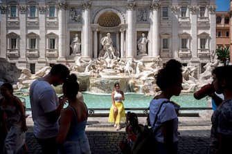 ROME, ITALY - JULY 31: Tourists visit the Fontana di Trevi (Trevi Fountain) as temperatures reach 44 degrees Celsius, on July 31, 2020 in Rome, Italy. Italy is set to experience its first heatwave of the year this week and today the thermometers in Rome registered more than 40 degrees Celsius. (Photo by Antonio Masiello/Getty Images)