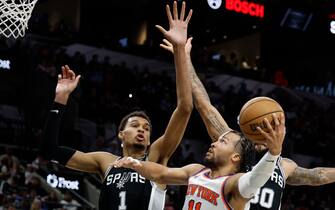 SAN ANTONIO, TX - MARCH 29: Jalen Brunson #11 of the New York Knicks drives on Victor Wembanyama #1 of the San Antonio Spurs during the second half at Frost Bank Center on March 29, 2024 in San Antonio, Texas. NOTE TO USER: User expressly acknowledges and agrees that, by downloading and or using this photograph, User is consenting to terms and conditions of the Getty Images License Agreement. (Photo by Ronald Cortes/Getty Images)