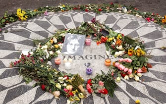25th Anniversary memorial of the day John Lennon was shot, Strawberry Fields, 72 Street 
Central Park West, NYC                               
