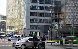 Police officers block off an area around a damaged office block of the Moscow International Business Center (Moskva City) following a reported drone attack in Moscow on July 30, 2023. Three Ukrainian drones were downed over Moscow early on July 30, 2023, Russia's defence ministry said, in an attack that briefly shut an international airport. While one of the drones was shot down on the city's outskirts, two others were "suppressed by electronic warfare" and smashed into an office complex. No one was injured. (Photo by Alexander NEMENOV / AFP) (Photo by ALEXANDER NEMENOV/AFP via Getty Images)
