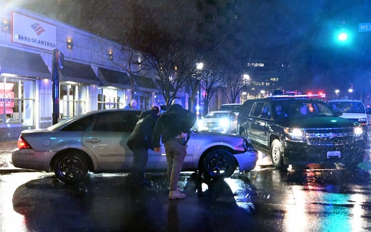 Members of the US Secret Service rush to a car, after it hit a motorcade SUV, as US president Joe Biden was leaving his campaign headquarters in Wilmington, Delaware on December 17, 2023. (Photo by ANDREW CABALLERO-REYNOLDS / AFP) (Photo by ANDREW CABALLERO-REYNOLDS/AFP via Getty Images)