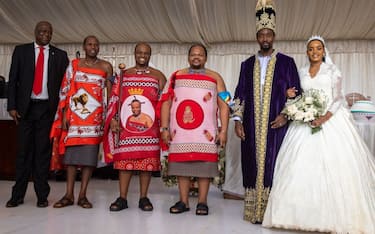 The Kyabazinga (King) of the Busoga Kingdom William Gabula Nadiope IV (2nd R) and the Inhebantu (Queen) Jovia Mutesi (R) stand in the altar while posing for a photo with a delegation of members from the royal family of the Kingdom of Eswatini during their royal wedding at the Christ's Cathedral Bugembe in Jinja on November 18, 2023. (Photo by BADRU KATUMBA / AFP) (Photo by BADRU KATUMBA/AFP via Getty Images)