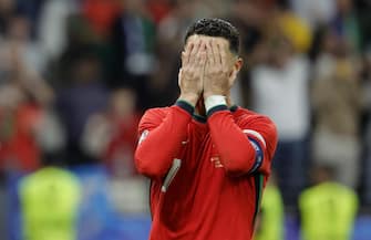epa11451284 Cristiano Ronaldo of Portugal reacts after failing to score from the penalty spot during extra time of the UEFA EURO 2024 Round of 16 soccer match between Portugal and Slovenia, in Frankfurt Main, Germany, 01 July 2024.  EPA/RONALD WITTEK