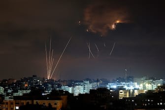 A picture taken on August 5, 2022, shows Palestinian rockets fired from Gaza City in retaliation to earlier Israeli airstrikes, and Israeli Iron Dome system missiles intercepting them. - A senior militant from Islamic Jihad was killed in an Israeli air strike on the Gaza Strip today, prompting the militant group to warn Israel has "started a war".
A child was among those killed in the strikes, the enclave's health ministry said, while Israel's military estimated 15 were dead. (Photo by MOHAMMED ABED / AFP) (Photo by MOHAMMED ABED/AFP via Getty Images)