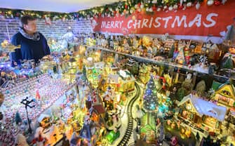 30 November 2023, Lower Saxony, Rinteln: Susanne Jeromin stands in her house in the district of Schaumburg. 555 Christmas trees and almost 108,000 Christmas baubles: During Advent, the Jeromin family's house shines as a colorful Christmas world. Photo: Julian Stratenschulte/dpa (Photo by Julian Stratenschulte/picture alliance via Getty Images)