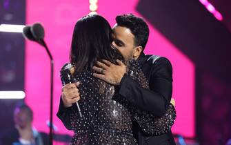SEVILLE, SPAIN - NOVEMBER 15: (L-R) Laura Pausini and Luis Fonsi embrace onstage during the Latin Recording Academy Person of The Year Honoring Laura Pausini at FIBES Conference and Exhibition Centre on November 15, 2023 in Seville, Spain. (Photo by Rodrigo Varela/Getty Images for Latin Recording Academy)