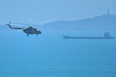 A Chinese military helicopter flies past Pingtan island, one of mainland China's closest point from Taiwan, in Fujian province on August 4, 2022, ahead of massive military drills off Taiwan following US House Speaker Nancy Pelosi's visit to the self-ruled island. - China is due on August 4 to kick off its largest-ever military exercises encircling Taiwan, in a show of force straddling vital international shipping lanes following a visit to the self-ruled island by US House Speaker Nancy Pelosi. (Photo by Hector RETAMAL / AFP) (Photo by HECTOR RETAMAL/AFP via Getty Images)